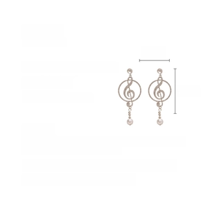 Detail view of G-clef earrings with shimmering rhinestones and a hanging round pearl