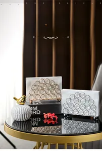 Detail of luxury crystal napkin holder with gold and silver metal frames for dining table