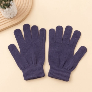 Detail of warm knit winter gloves with wide ribbed elastic cuffs and fine texture