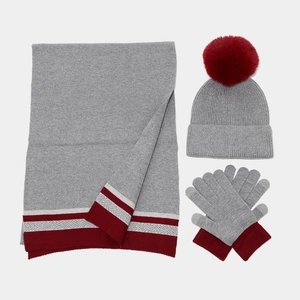 Women's grey winter knit set with pom-pom hat, striped scarf and matching gloves