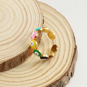 Detail of 18K gold stainless steel ring with colorful enamel evil eye patterns