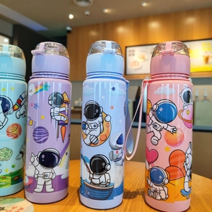 Detailed lineup of four colorful cartoon astronaut water bottles on a wooden table