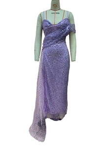 Detail of lavender sequin evening gown with side drape and high slit on a mannequin