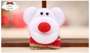 Detail of a white bear plush brooch with red nose and plaid scarf for Christmas