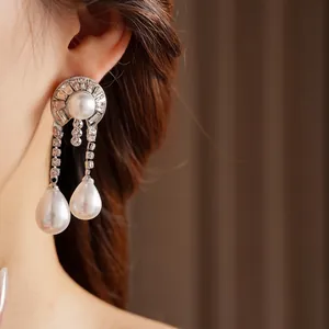 Elegant silver tassel earrings with round and teardrop pearls and shimmering zircons