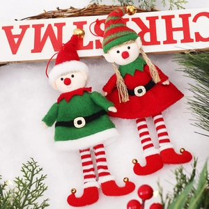 Christmas elf doll hanging ornaments with bells and striped legs on snowy background