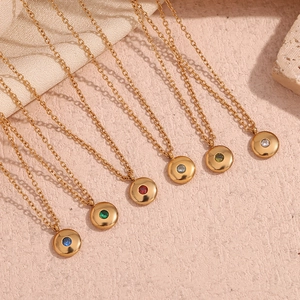 Detail of 18K gold-plated birthstone pendant necklaces with colorful round zircons