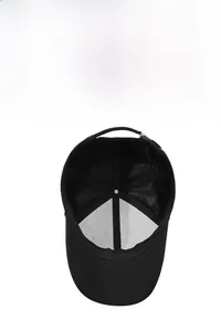 Internal detail of a black cap featuring breathable eyelets and adjustable metal buckle