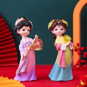 Detailed view of Q-version resin figurines holding a lantern and fan with floral backdrop