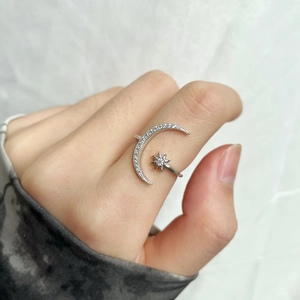 Detail of S925 sterling silver moon and star open ring with micro-pave zircon stones