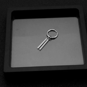 Detail of silver stainless steel drop earring with dual rectangular bar pendants