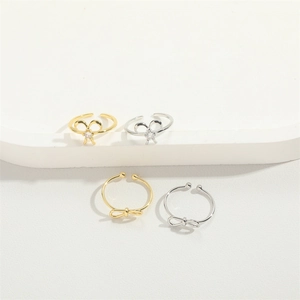 Minimalist adjustable bow rings set in gold and silver finish with sparkling stones