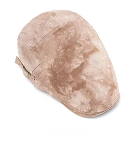 Top view of vintage khaki newsboy cap showing tie-dye texture and canvas fabric detail