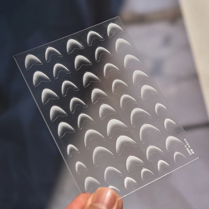 Close-up of frosted French manicure guide stickers for gradient nail art styling