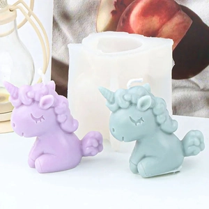 Detailed view of translucent silicone unicorn mold alongside purple and green candles