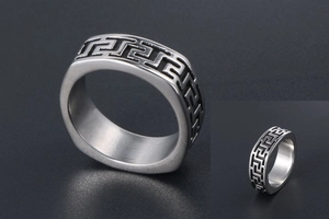Macro view of men's titanium steel ring with intricate Greek meander engraving details