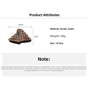 Macro detail of acrylic hair claw with brown plaid fabric and a wooden button