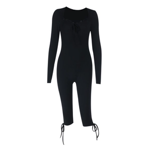 Detailed view of black lace jumpsuit featuring neck ties and stylish ankle lace-up ribbons