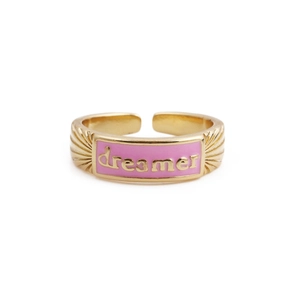 Macro detail of gold-plated copper ring featuring pink enamel and dreamer engraving