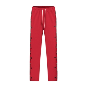 Detail of men's red leisure pants with side plaid patchwork and black metal snap buttons