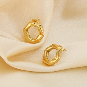 Close-up of 18K gold plated hexagonal hollow earrings on champagne silk background