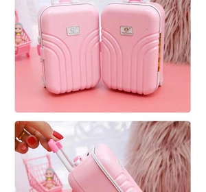 Detail view of pink mini suitcase toy with adjustable handles and functional storage