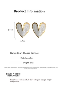Detail of vintage heart stud earrings showing 1.8cm x 1.7cm dimensions and cream enamel