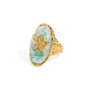 Golden starfish ring with blue marble inlay and textured band for a coastal beach style