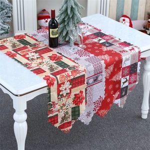 Close-up of Christmas table runner with reindeer and snowflake patterns and wavy edges