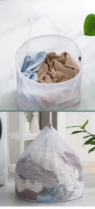 Detail of large fine mesh laundry bag with black drawstring closure for washing machines