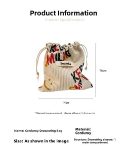 Detailed view of beige corduroy drawstring bag with smiley print measuring 14x16cm