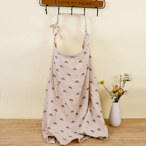 Detail of soft muslin cotton nursing cover featuring a brown rainbow pattern and top strap