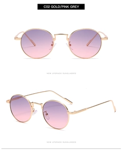 Detail view of gold round sunglasses with pink-grey gradient lenses and slim metal frame
