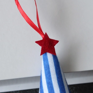 Patriotic faceless gnome Christmas ornament with blue white stripes and red felt star