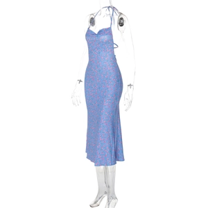 Detail shot of blue floral midi dress with backless halter neck and side slit design