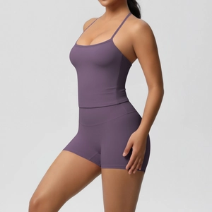 Close-up of purple two-piece yoga set featuring thin strap camisole and high waist shorts