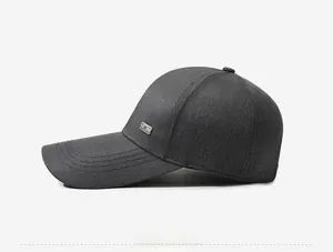 Side view of dark gray breathable baseball cap with side rectangular metal logo accent