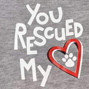 Detail of grey cotton dog vest showing You Rescued My lettering and red paw print