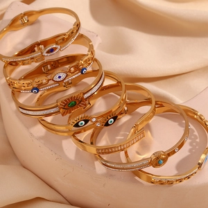 Detailed macro view of 18K gold-plated evil eye bracelets with micro-pave zircons