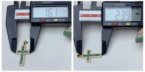 Close-up showing the cross pendant dimensions: 16.1mm width and 23.9mm height on a digital caliper