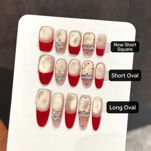 Red cat-eye handmade press-on nails with snowflake and diamond accents in three shapes
