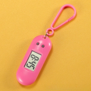 Close-up of pink portable triangular digital watch with LCD screen and snap hook