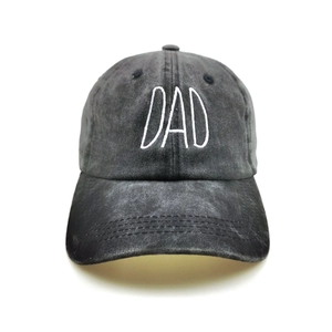 Detailed view of white DAD 3D embroidery on washed charcoal grey cotton baseball cap