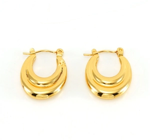 Detail view of 18K gold double U-shaped hoop earrings with a polished metallic finish
