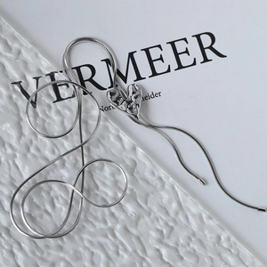 Silver liquid metal heart pendant necklace with snake chain on aesthetic background