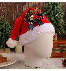 Detailed view of red plush Christmas hat with blue star bow and festive berry decor