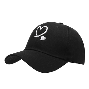 Minimalist black baseball cap with white heart embroidery in a side 45-degree angle view