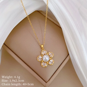 Detail of gold floral necklace with white pearl and zircons in a jewelry box