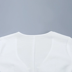 Detail view showing the fine stitching and smooth neckline of a white V-neck dress
