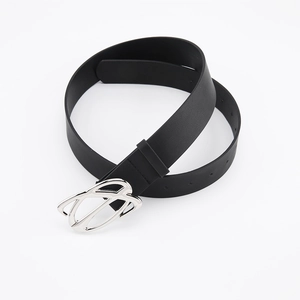 Close-up of a black leather belt with a silver irregular shaped metal buckle detail